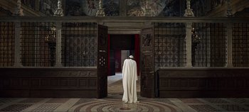 Movie still from “The Agony and the Ecstasy” (1965), directed by Carol Reed – A man standing in front of an open door; Extreme Wide shot, High angle