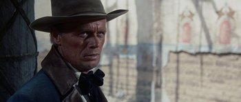 Movie still from “The Alamo” (1960), directed by John Wayne – A person wearing a hat and a bow tie; Close Up shot, Over the shoulder angle