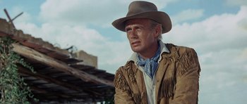 Movie still from “The Alamo” (1960), directed by John Wayne – A man wearing a cowboy hat and a jacket; Close Up shot, Low angle