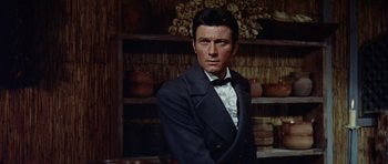 Movie still from “The Alamo” (1960), directed by John Wayne – A person wearing a suit and tie; Close Up shot, Low angle