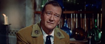 Movie still from “The Alamo” (1960), directed by John Wayne – A person wearing a suit and tie; Close Up shot, Over the shoulder angle