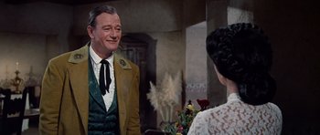 Movie still from “The Alamo” (1960), directed by John Wayne – A man and a woman are talking to each other; Medium shot, Over the shoulder angle