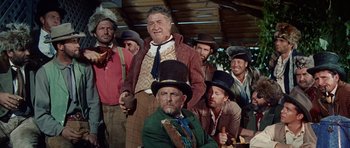 Movie still from “The Alamo” (1960), directed by John Wayne – A group of men wearing hats and ties; Medium shot, Low angle