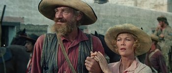 Movie still from “The Alamo” (1960), directed by John Wayne – An older man and woman wearing hats and a long beard; Close Up shot, Low angle