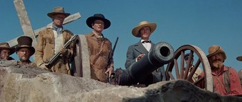 Movie still from “The Alamo” (1960), directed by John Wayne – Two men dressed in western clothing and hats; Medium shot, Low angle