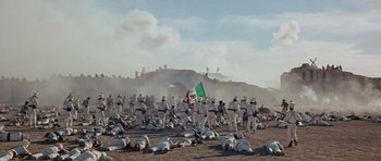 Movie still from “The Alamo” (1960), directed by John Wayne – A large group of people in white uniforms and helmets; Extreme Wide shot, High angle