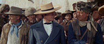 Movie still from “The Alamo” (1960), directed by John Wayne – A man wearing a straw hat; Close Up shot, Over the shoulder angle