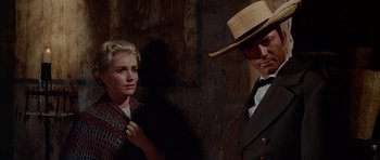 Movie still from “The Alamo” (1960), directed by John Wayne – A man and a woman standing next to each other; Close Up shot, Over the shoulder angle