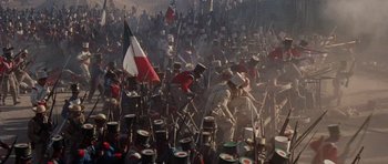 Movie still from “The Alamo” (1960), directed by John Wayne – A large crowd of people are gathered together in a field; Extreme Wide shot, High angle