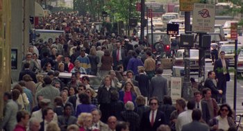 Movie still from “The Ambulance” (1990), directed by Larry Cohen – A large group of people walking down a street; Extreme Wide shot, High angle