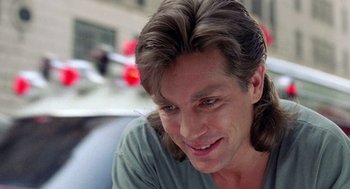 Movie still from “The Ambulance” (1990), directed by Larry Cohen – A person with long brown hair; Close Up shot, Over the shoulder angle