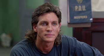 Movie still from “The Ambulance” (1990), directed by Larry Cohen – A person with long brown hair; Close Up shot, Over the shoulder angle