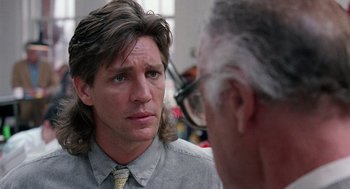 Movie still from “The Ambulance” (1990), directed by Larry Cohen – A man with long hair talking to another man; Close Up shot, Over the shoulder angle