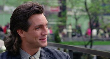 Movie still from “The Ambulance” (1990), directed by Larry Cohen – A person wearing a suit and tie; Close Up shot, Over the shoulder angle