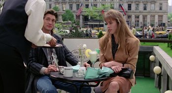 Movie still from “The Ambulance” (1990), directed by Larry Cohen – A man and a woman sitting at an outdoor table; Medium shot, Over the shoulder angle