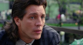 Movie still from “The Ambulance” (1990), directed by Larry Cohen – A person wearing a suit and tie; Close Up shot, Over the shoulder angle