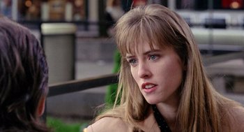 Movie still from “The Ambulance” (1990), directed by Larry Cohen – A person with long blonde hair; Close Up shot, Over the shoulder angle