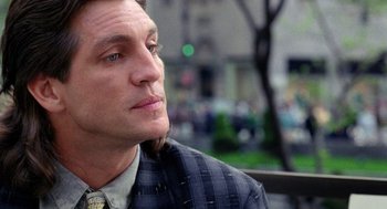 Movie still from “The Ambulance” (1990), directed by Larry Cohen – A person wearing a suit and tie; Close Up shot, Over the shoulder angle