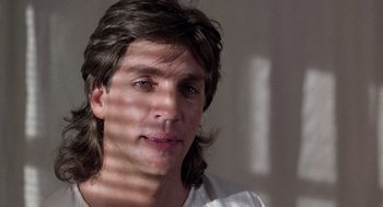 Movie still from “The Ambulance” (1990), directed by Larry Cohen – A person with long brown hair; Close Up shot, Low angle