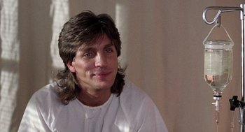 Movie still from “The Ambulance” (1990), directed by Larry Cohen – A person with long hair; Close Up shot, Low angle