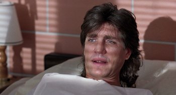 Movie still from “The Ambulance” (1990), directed by Larry Cohen – A person laying in a hospital bed; Close Up shot, Low angle