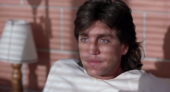 Movie still from “The Ambulance” (1990), directed by Larry Cohen – A person with long brown hair; Close Up shot, Low angle