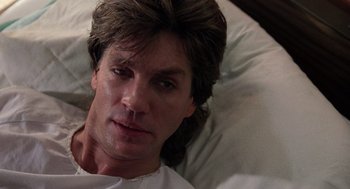 Movie still from “The Ambulance” (1990), directed by Larry Cohen – A person laying in a bed; Close Up shot, Low angle