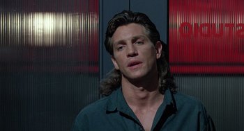 Movie still from “The Ambulance” (1990), directed by Larry Cohen – A person with long hair; Close Up shot, Low angle