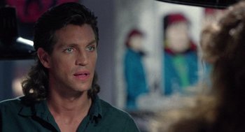 Movie still from “The Ambulance” (1990), directed by Larry Cohen – A person wearing a green shirt; Close Up shot, Over the shoulder angle