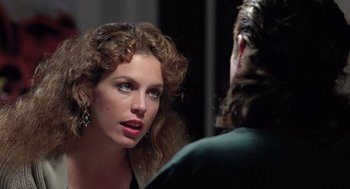 Movie still from “The Ambulance” (1990), directed by Larry Cohen – A beautiful woman looking into a mirror while standing next to a man; Close Up shot, Over the shoulder angle