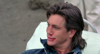 Movie still from “The Ambulance” (1990), directed by Larry Cohen – A person wearing a jean jacket; Close Up shot, Over the shoulder angle