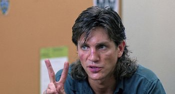 Movie still from “The Ambulance” (1990), directed by Larry Cohen – A man making a peace sign with his hand; Close Up shot, Over the shoulder angle