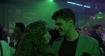 Movie still from “The Ambulance” (1990), directed by Larry Cohen – A man and a woman are smiling at each other; Close Up shot, Over the shoulder angle