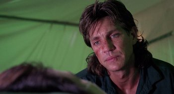 Movie still from “The Ambulance” (1990), directed by Larry Cohen – A person with long brown hair; Close Up shot, Low angle