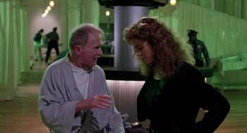 Movie still from “The Ambulance” (1990), directed by Larry Cohen – A man and a woman talking to each other; Medium shot, Over the shoulder angle
