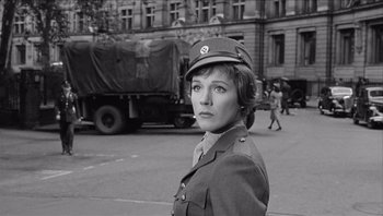 Movie still from “The Americanization of Emily” (1964), directed by Arthur Hiller – A black and white photo of a woman in a military uniform; Close Up shot, Low angle