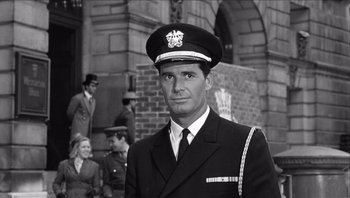 Movie still from “The Americanization of Emily” (1964), directed by Arthur Hiller – Black and white photograph of a man in a military uniform; Close Up shot, Low angle