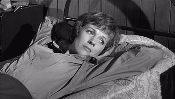 Movie still from “The Americanization of Emily” (1964), directed by Arthur Hiller – A black and white photo of a woman laying in a bed; Close Up shot, High angle