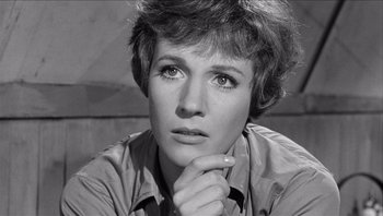 Movie still from “The Americanization of Emily” (1964), directed by Arthur Hiller – A black - and - white photo of julie andrews looking pensive; Close Up shot, High angle