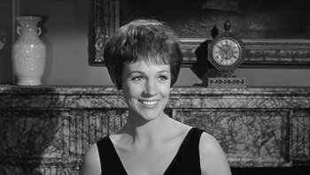 Movie still from “The Americanization of Emily” (1964), directed by Arthur Hiller – Black and white photograph of a woman in front of a fireplace; Close Up shot, Over the shoulder angle