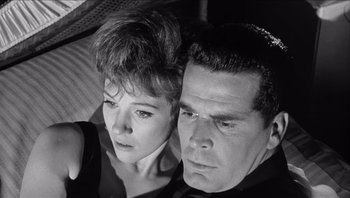 Movie still from “The Americanization of Emily” (1964), directed by Arthur Hiller – A man and a woman looking at the camera; Close Up shot, High angle