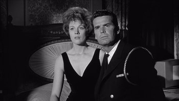Movie still from “The Americanization of Emily” (1964), directed by Arthur Hiller – A man and a woman posing for a picture; Medium shot, Low angle