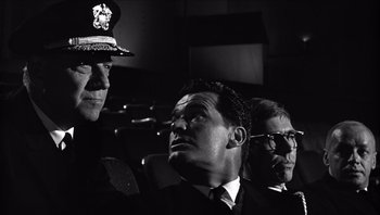 Movie still from “The Americanization of Emily” (1964), directed by Arthur Hiller – A black and white photo of three men in suits and ties; Medium shot, Low angle