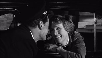 Movie still from “The Americanization of Emily” (1964), directed by Arthur Hiller – A man and a woman are sitting in the back of a car; Close Up shot, High angle