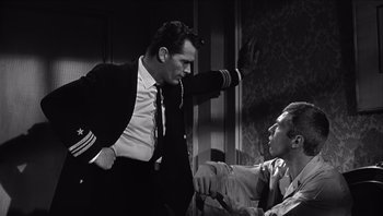 Movie still from “The Americanization of Emily” (1964), directed by Arthur Hiller – Two men in a room one is wearing a suit and the other is wearing a tie; Medium shot, Low angle