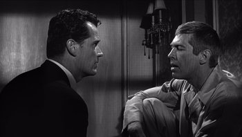 Movie still from “The Americanization of Emily” (1964), directed by Arthur Hiller – Two men in suits are talking to each other; Close Up shot, Over the shoulder angle