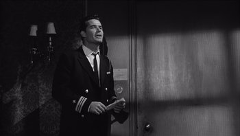 Movie still from “The Americanization of Emily” (1964), directed by Arthur Hiller – Black and white photograph of a man in a uniform; Medium shot, Low angle