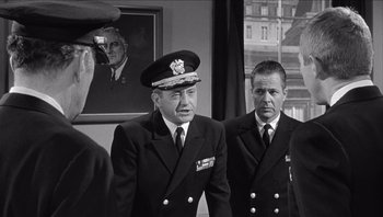 Movie still from “The Americanization of Emily” (1964), directed by Arthur Hiller – A black and white photo of two men in military uniforms; Medium shot, Over the shoulder angle