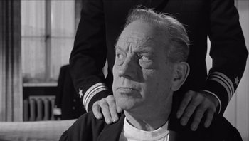 Movie still from “The Americanization of Emily” (1964), directed by Arthur Hiller – An older man is being hugged by a younger man; Close Up shot, Low angle