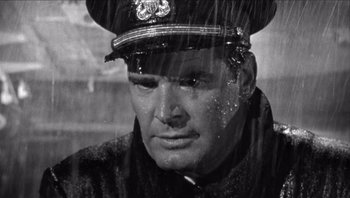 Movie still from “The Americanization of Emily” (1964), directed by Arthur Hiller – A black and white photo of a man wearing a uniform; Close Up shot, Low angle